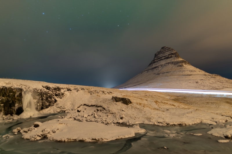 Mt. Kirkjufell under the Northern Lights / Aurora Borealis draped in snow in Iceland photographed by Adventure Photographer, Dailyn Matthews