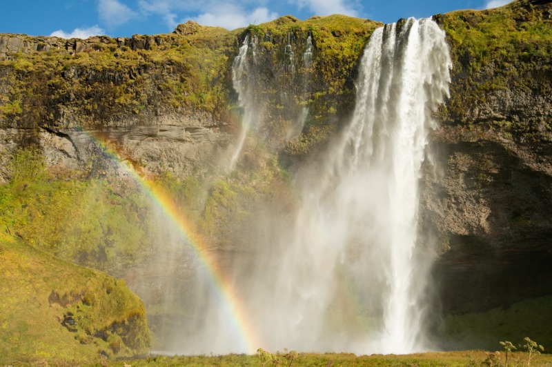 Seljalandsfoss waterfall with a rainbow in Iceland photographed by Adventure Photographer, Dailyn Matthews