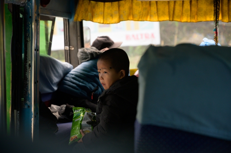 Nepali boy on a bus in Pohkara, Nepal photographed by Adventure Photographer, Dailyn Matthews