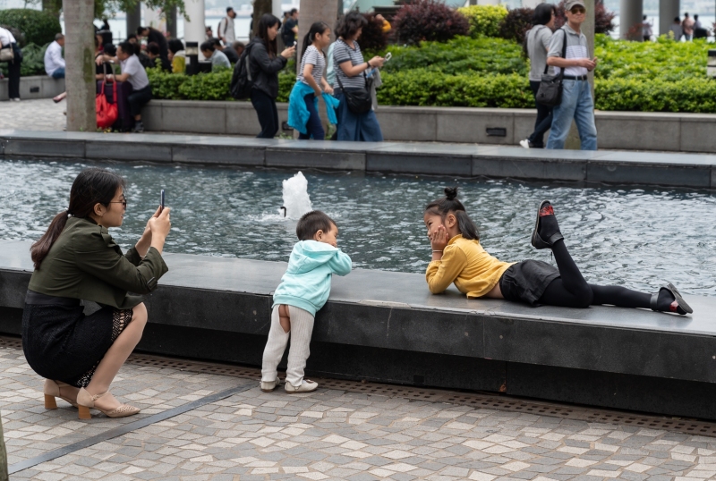Mother and children in Hong Kong taking photos (with boy's bum showing!) photographed by Adventure Photographer, Dailyn Matthews